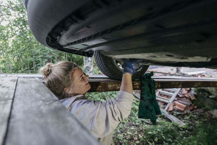 Woman repairing car