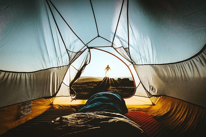 Low section of person relaxing in tent
