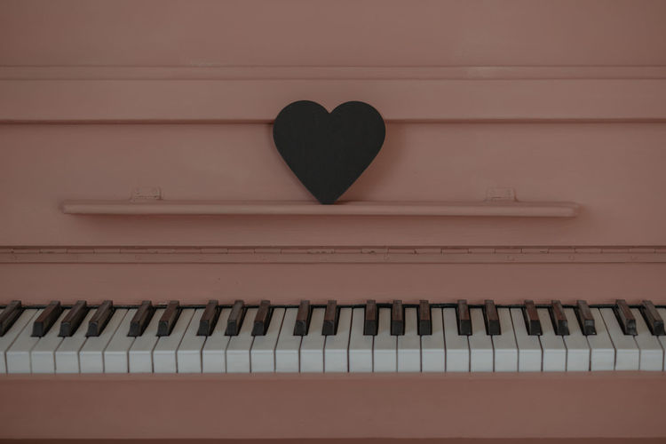 The concept of valentine's day. the heart is on the pink piano