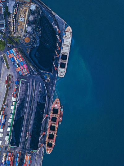 Russia, primorsky krai, vladivostok, aerial view of industrial ships moored in coal loading dock