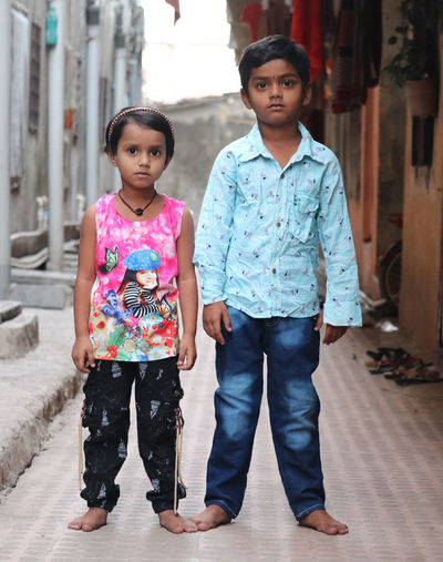 Full length portrait of happy siblings