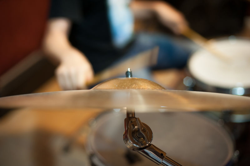 Close-up of cymbal with musician in background