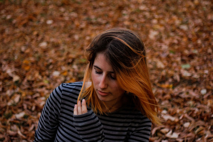 High angle view of teenage girl standing in park during autumn