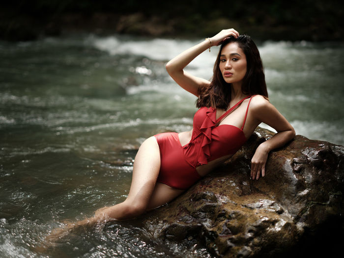 Young woman sitting in water