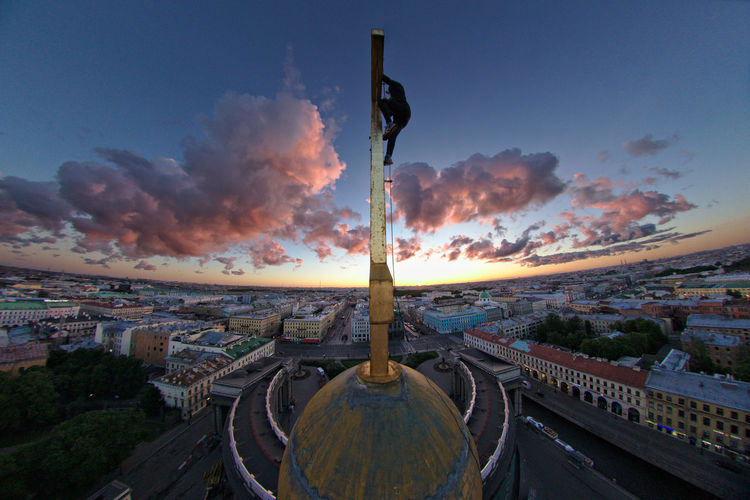 View of cityscape against cloudy sky
