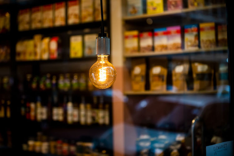 Illuminated light bulbs hanging on display at store