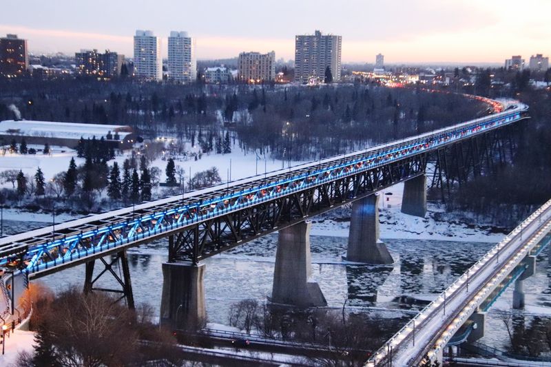 High angle view of bridge over river in city during winter