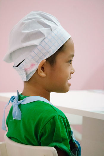 Close-up boy wearing chef hat