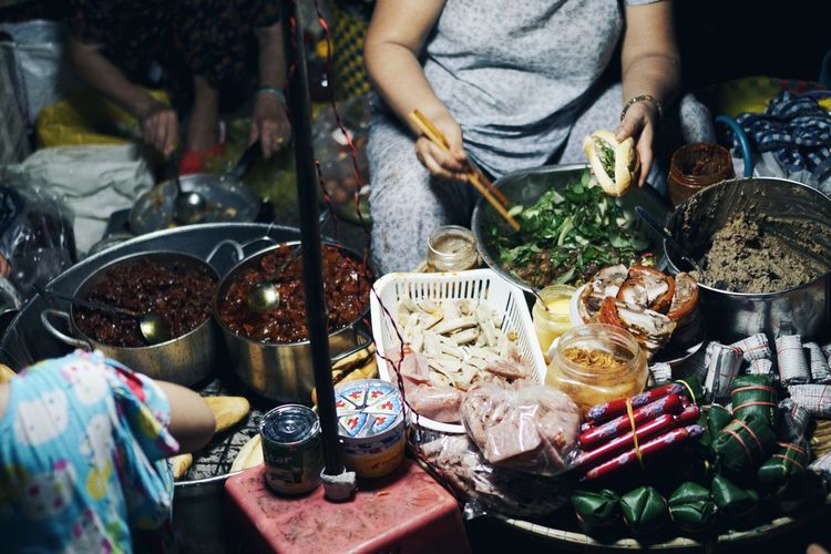 Midsection of man for sale at market stall