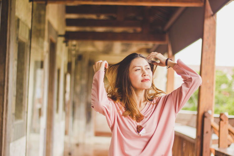 Beautiful mid adult woman standing in porch