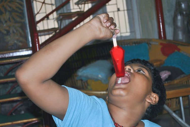 Close-up of boy eating popsicle