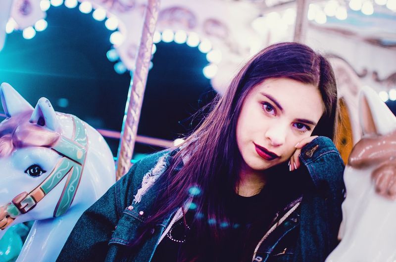 Portrait of beautiful woman standing outdoors at night