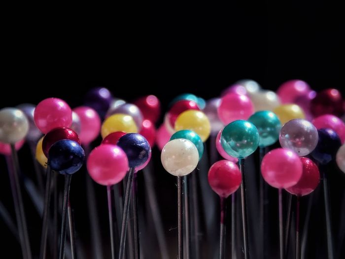 Close-up of multi colored balloons against black background