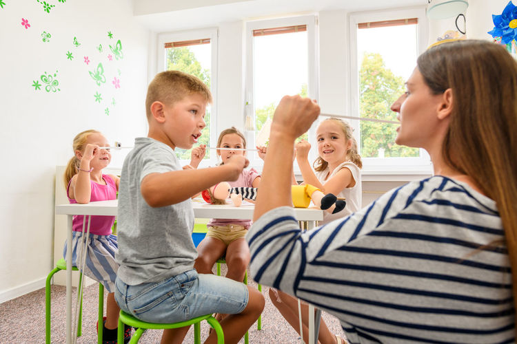 Child occupational therapy session. group of children doing playful exercises with their therapist.