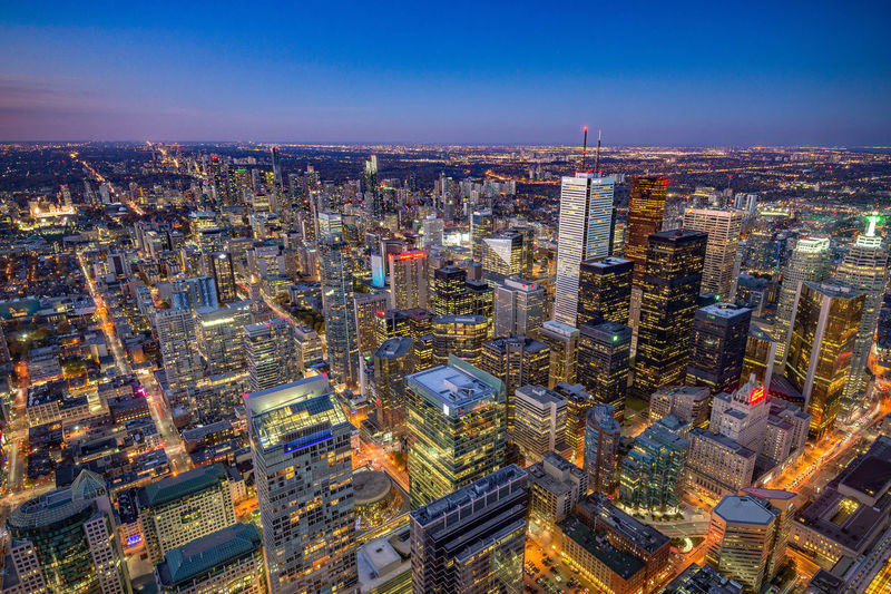 High angle view of illuminated city buildings against sky