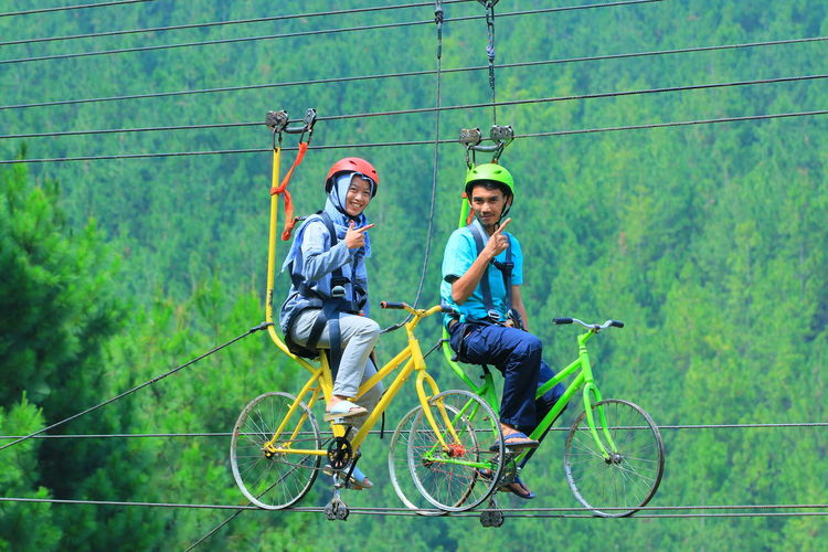 Young man riding bicycle on wall