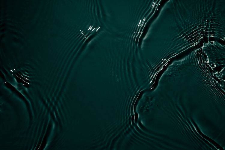 Black transparent clear calm water surface texture