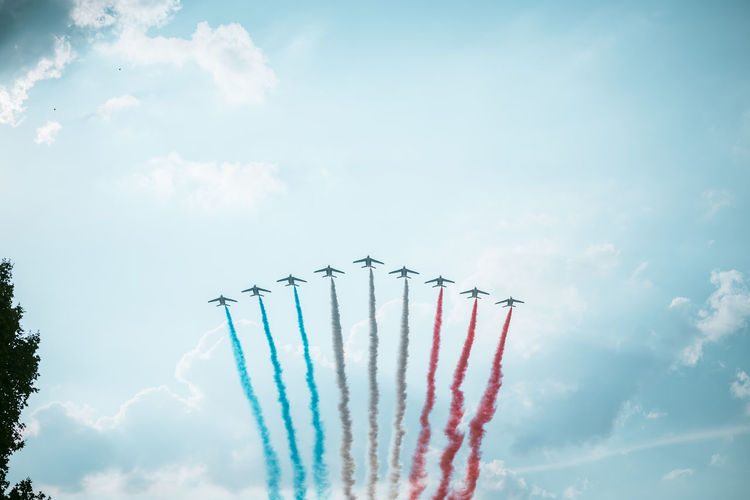 Low angle view of airshow against sky