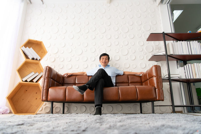 Portrait of man sitting on sofa