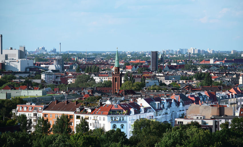 High angle view of houses in town against sky