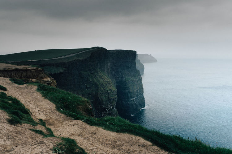 Scenic view of sea and mountain against sky