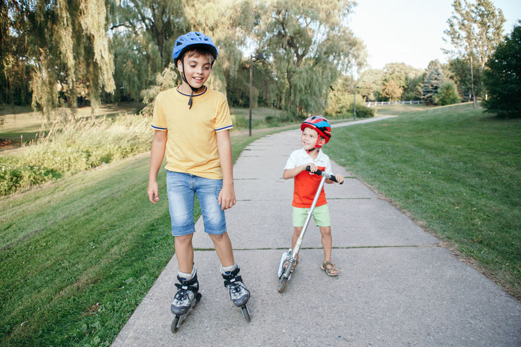 Full length of boys on footpath in park