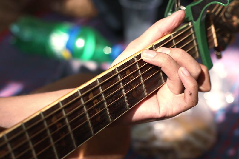 Close-up of man playing guitar