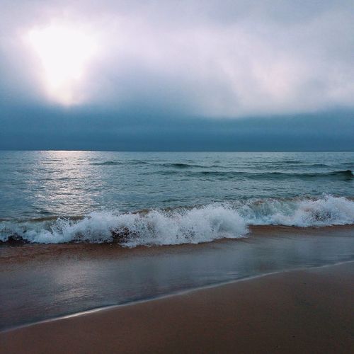 Scenic view of sea against cloudy sky