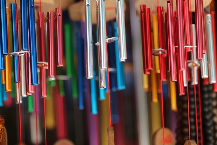 Close-up of colorful wind chimes hanging for sale at market