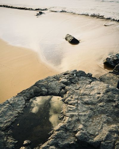High angle view of rocks on beach against sky