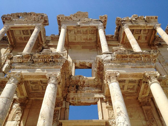 Low angle view of celsus library against clear blue sky