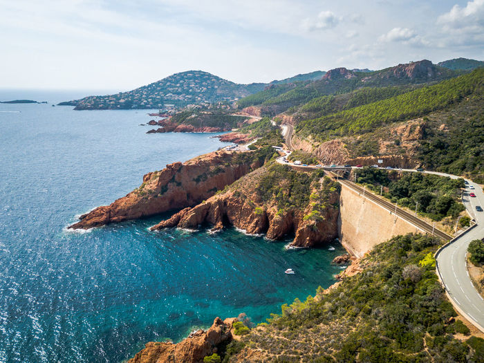 High angle view of sea and mountains against sky