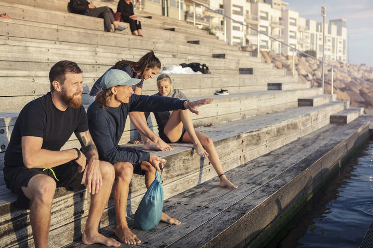 Group of people sitting by water
