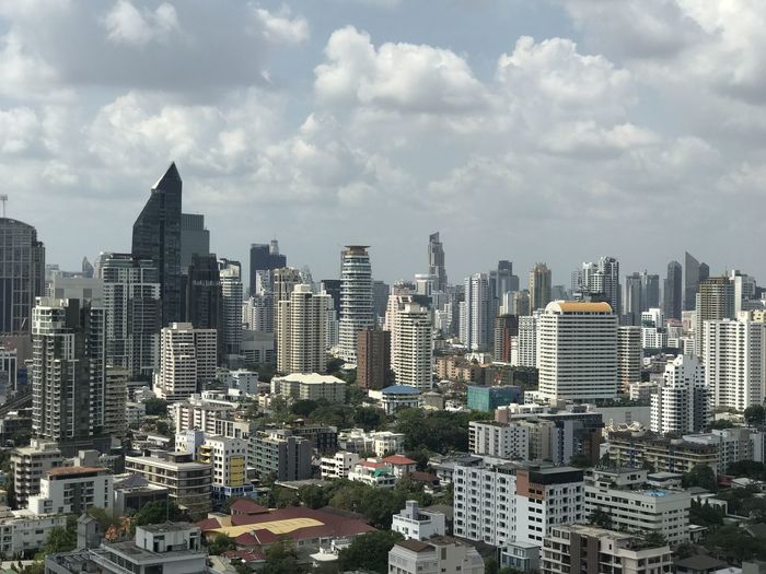 Aerial view of buildings in city against sky