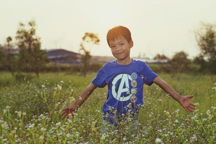 Boy standing on field