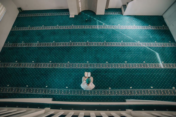 High angle view of man sitting on chair