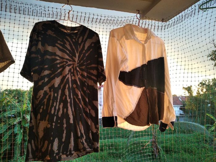 Clothes drying on grass against built structure