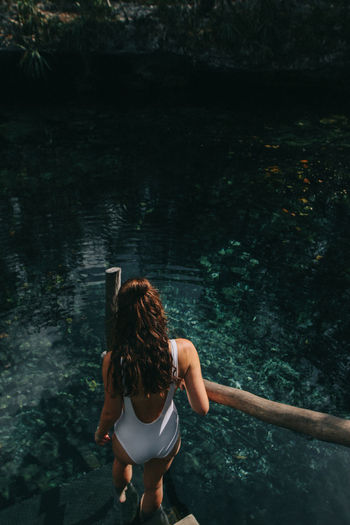 Girl walking on steps at Cenote Nicte Ha, Mexico Bathingsuit Beauty In Nature Cave Cenote Cenotes Fashion Girl High Angle View Lifestyles Mexico Nature Nature People Standing Steps Travel Travel Blogger Travel Photography Turquoise Water Water Women Young Women