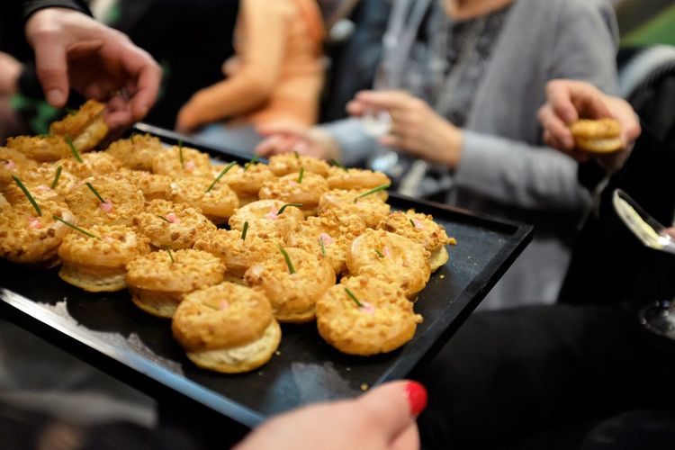 Cropped hand of woman serving food to friends during celebration