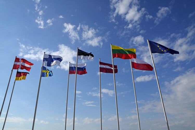 Low angle view of flags against sky