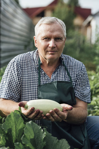 Gardener holding zucchini
