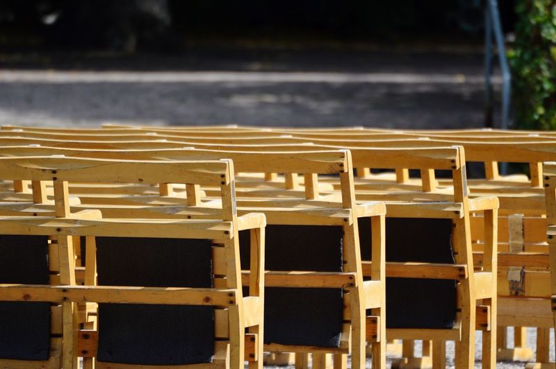 Close-up of chairs in row