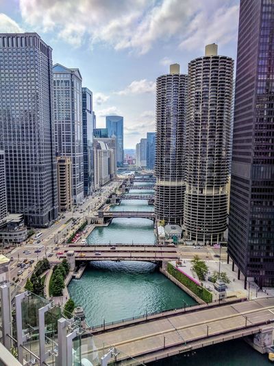 Aerial view of chicago river by buildings against sky