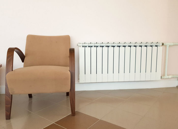 Empty chairs against wall at home