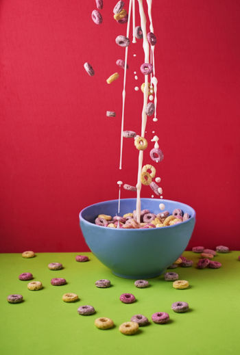 Milk with colored cereals flying