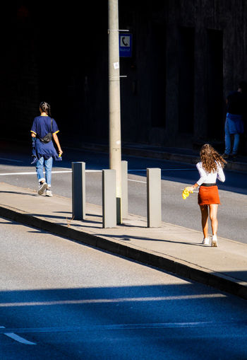 Rear view of couple walking in city