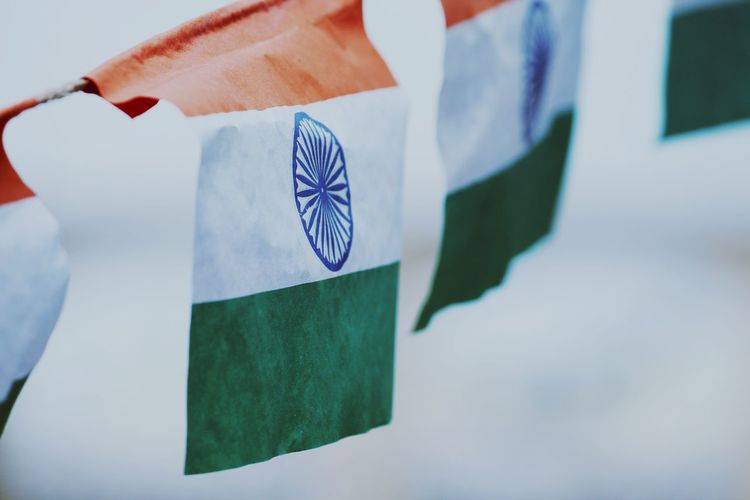 Close-up of indian flags against sky