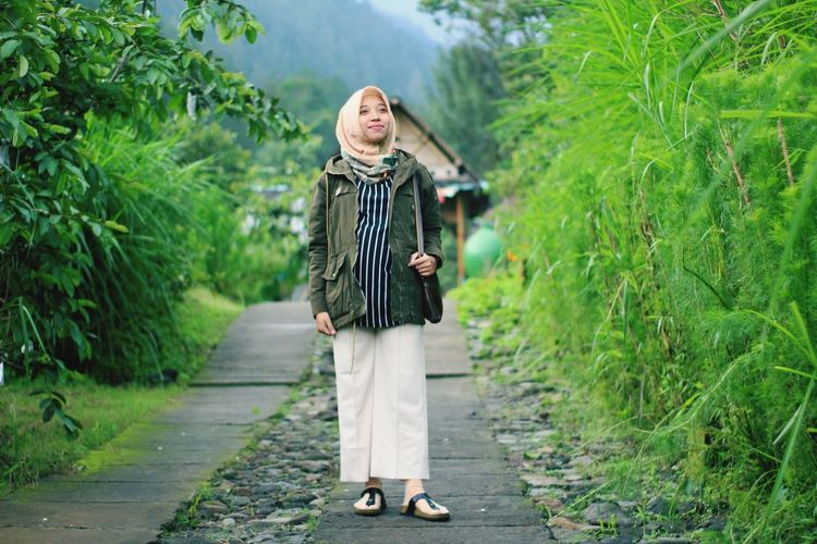 A pregnant woman smile in the park. taken at salatiga january 2020