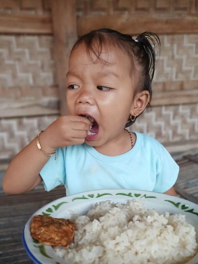 Portrait of cute boy eating food
