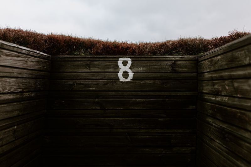 Text on wall against sky